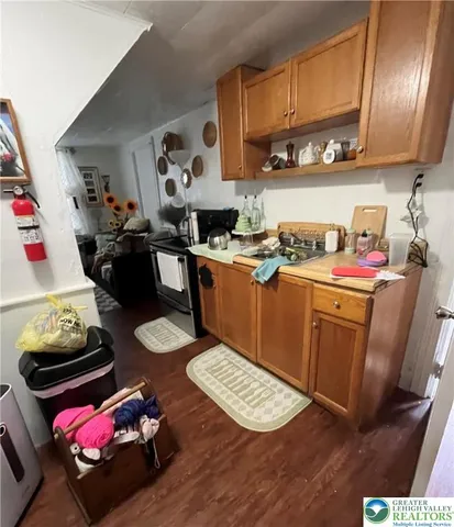 a room with furniture a flat screen tv and a refrigerator