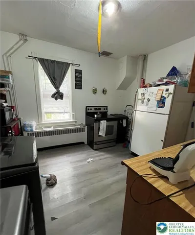 a bedroom with a bed and a flat tv screen