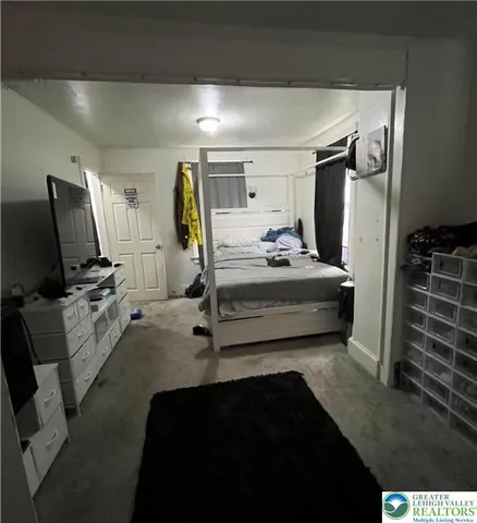 a bedroom with furniture and a window