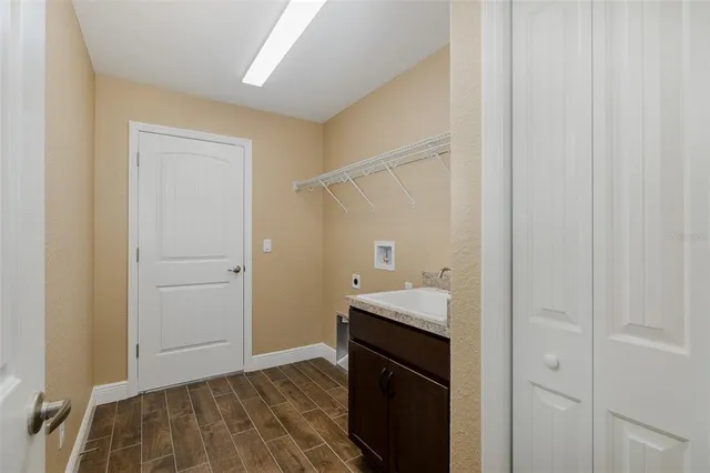 a spacious bathroom with a granite countertop double vanity sink a mirror and a