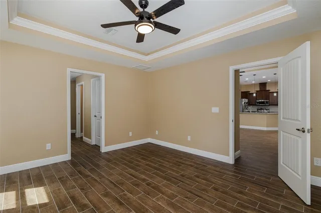 an empty room with closet and windows