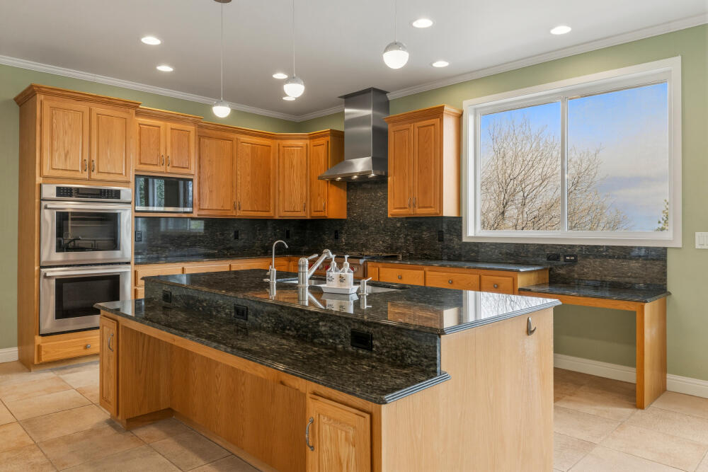 6586 Cooper's Hawk Road Klamath Falls, OR 97601 - Photo 14 of 68 a kitchen with stainless steel appliances granite countertop a sink a stove and a microwave