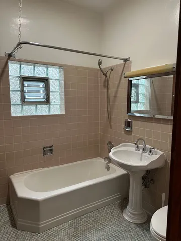 a room with a window and a dresser