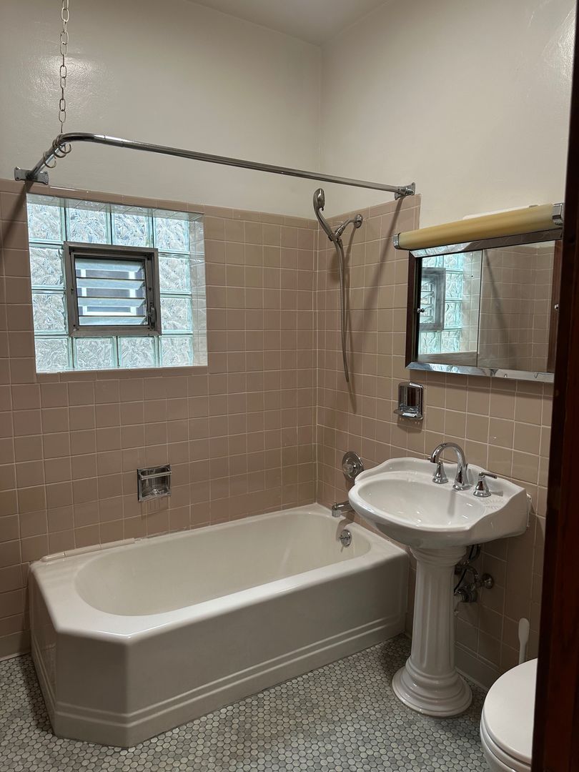 2611 West Walton Street, Unit 2 Chicago, IL 60622 - Photo 5 of 6 a bathroom with a sink and mirror