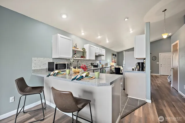 a view of a dining area kitchen with furniture and a wooden floor