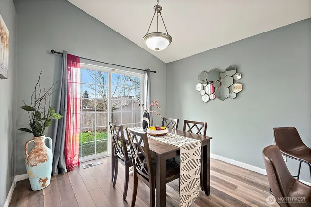 a dining room with furniture a window and a chandelier