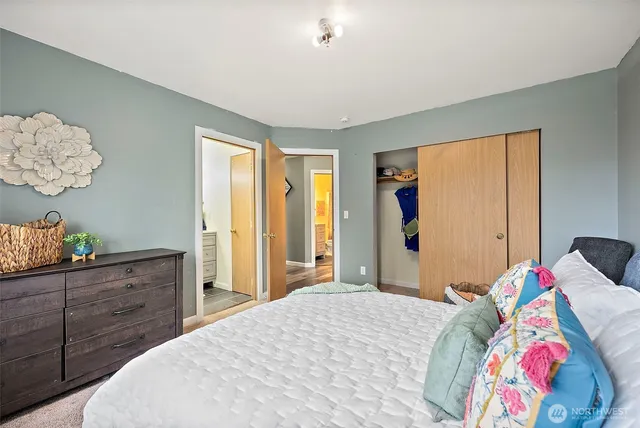 a bedroom with a bed and a dresser in it