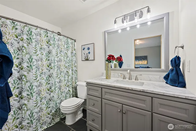 a bathroom with a toilet sink and mirror