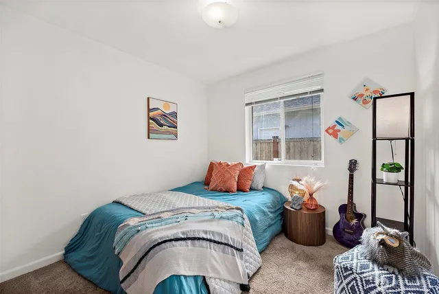 a bedroom with bed and a window