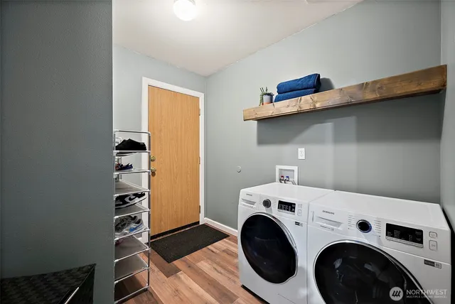 a utility room with dryer washer and a view of living room