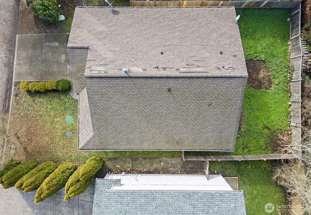 an aerial view of a house with a garden and lake view