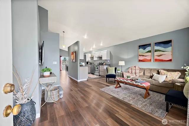 a living room with furniture and wooden floor