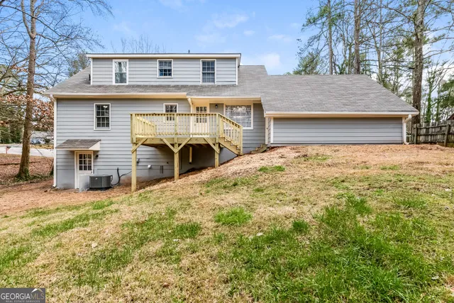 a front view of a house with a large tree