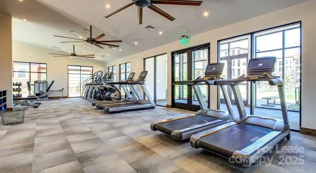 a living room with lots of furniture and a large window