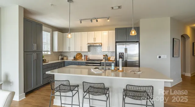 a bedroom with a bed and a flat tv screen on dresser