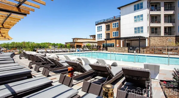 a view of swimming pool with outdoor seating and yard