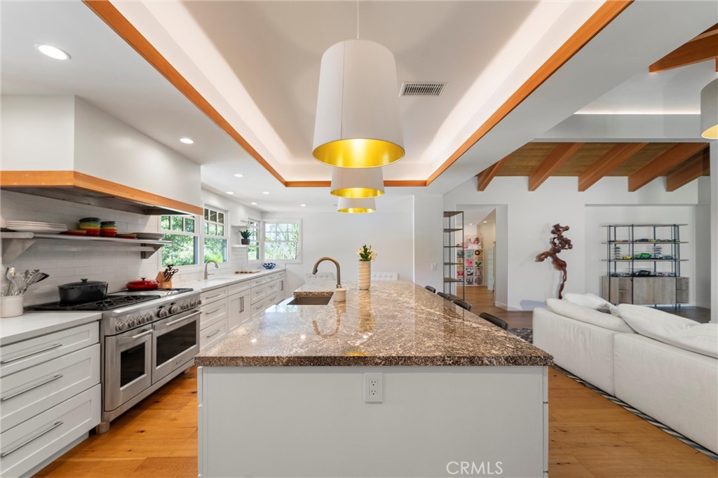 7337 La Soldadera Rancho Santa Fe, CA 92067 - Photo 4 of 60 a kitchen with stainless steel appliances granite countertop a sink a stove and a wooden floors