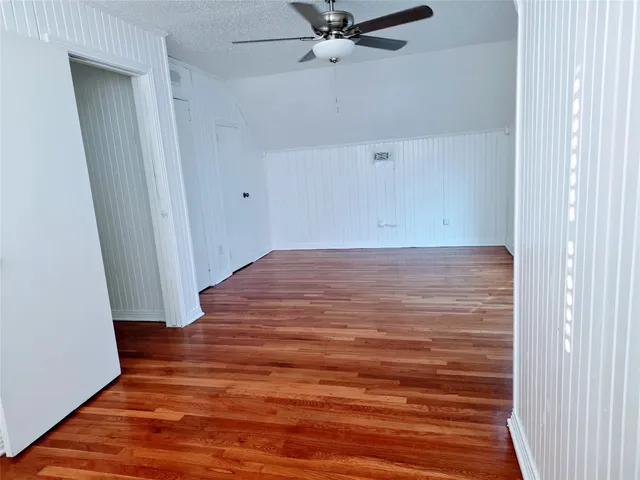 a view of a room with wooden floor