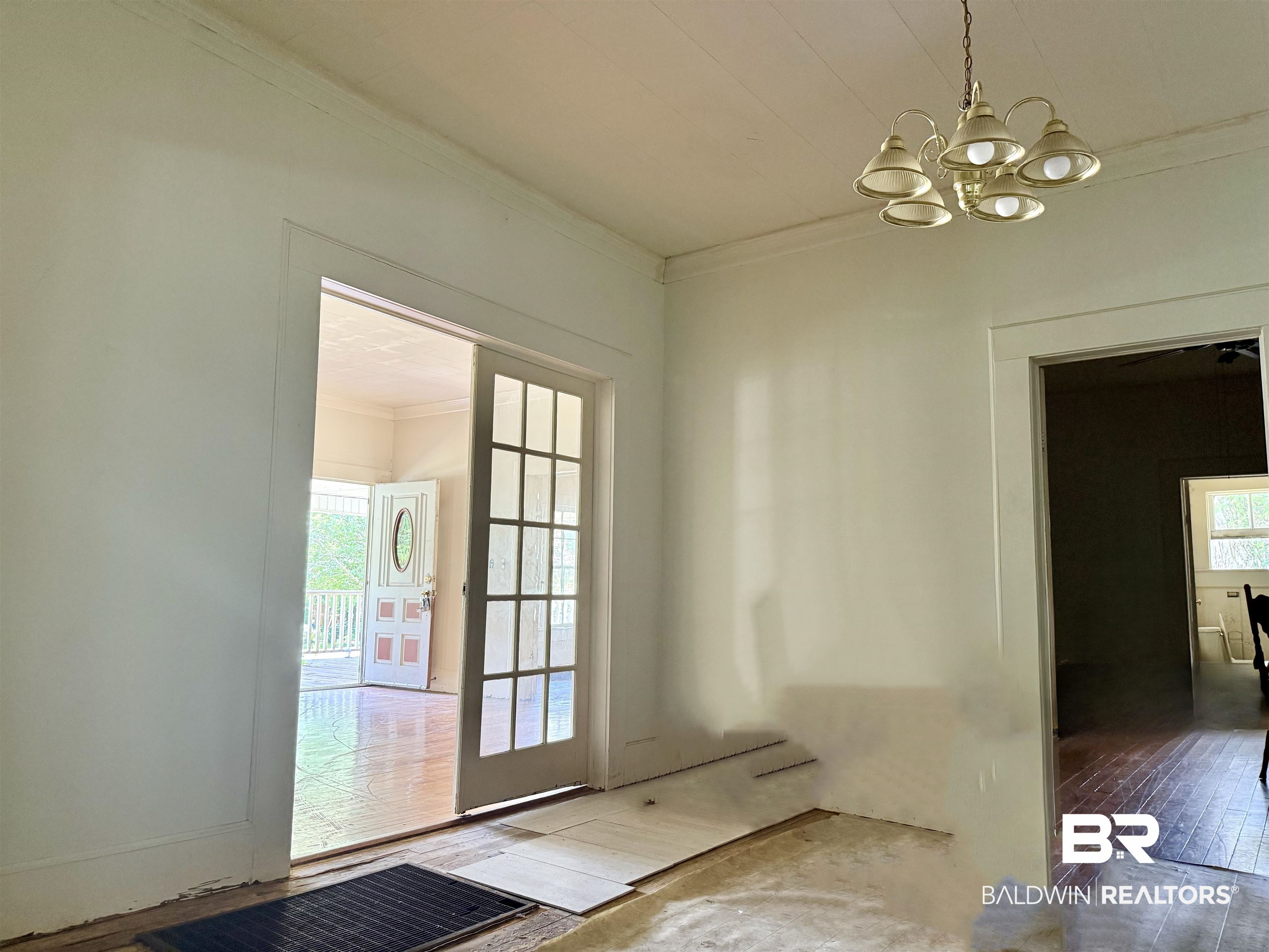 610 Alco Drive Brewton, AL 36426 - Photo 15 of 18 Entryway featuring crown molding, a chandelier, plenty of natural light, and hardwood / wood-style floors