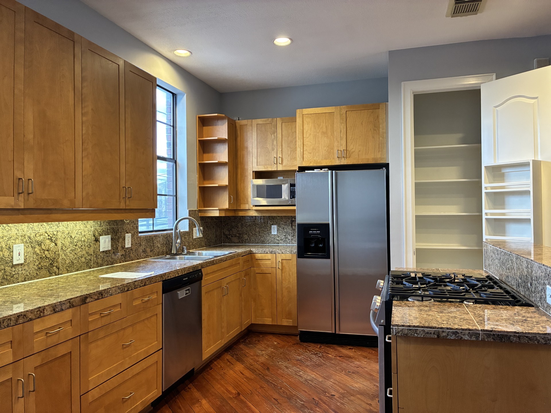 1000 Columbus Street, Unit C Houston, TX 77019 - Photo 12 of 24 a kitchen with a sink stove and refrigerator