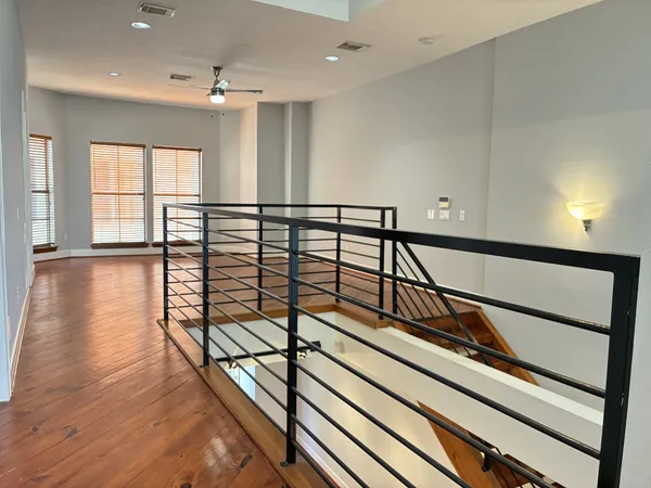 a view of staircase with lots of frames on the wall