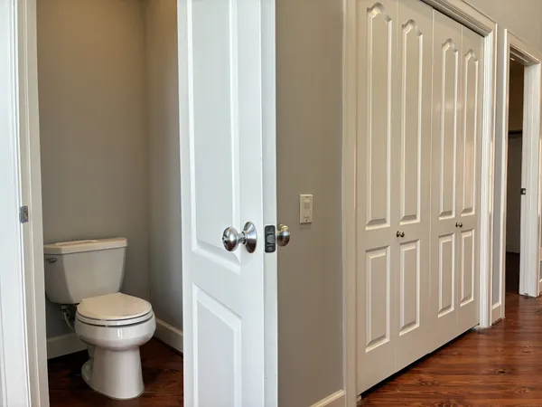 a white toilet sitting next to a bathroom sink