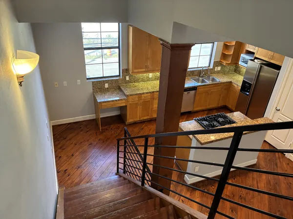 a view of a room with wooden floor and windows