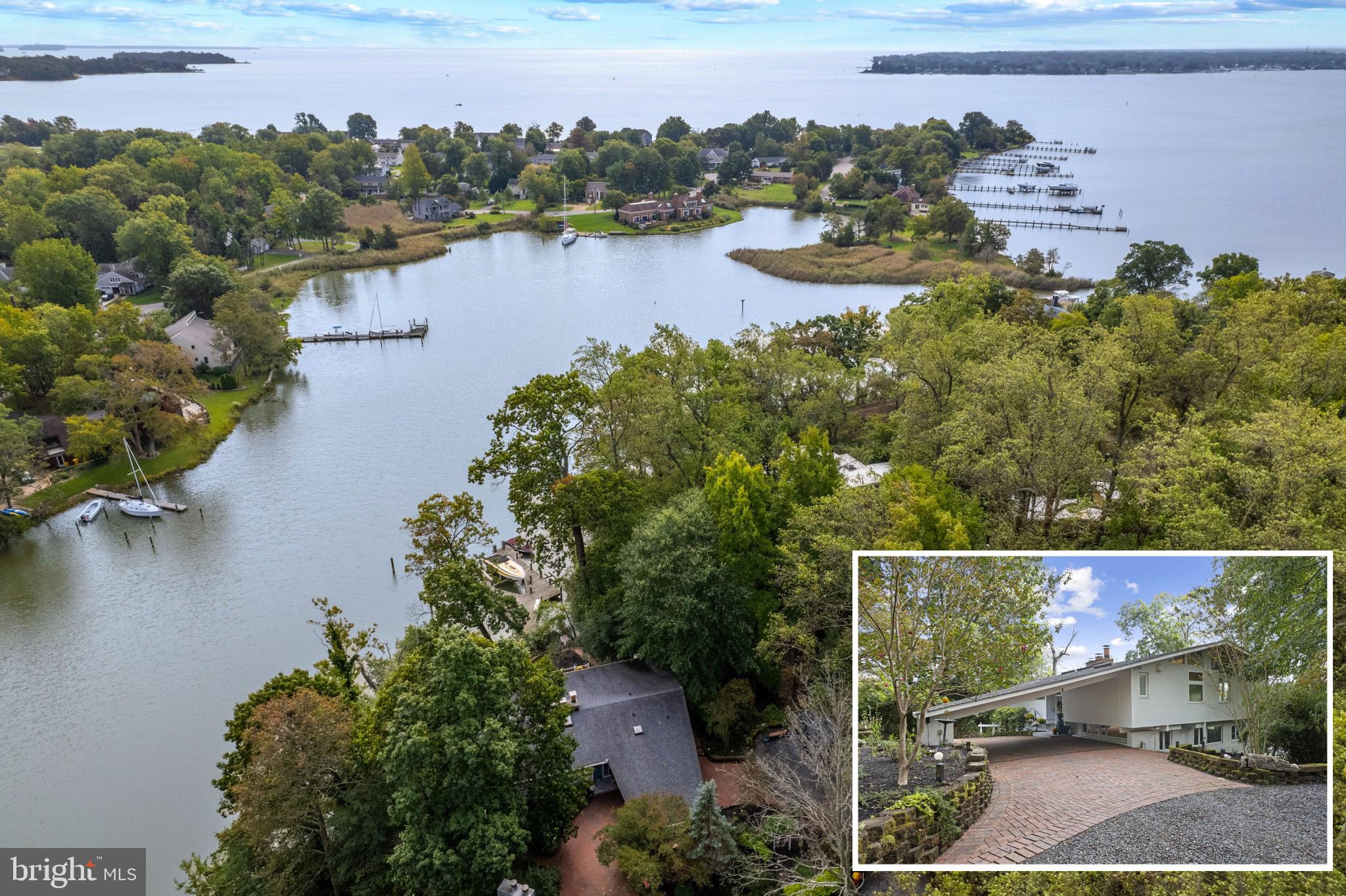an aerial view of lake residential house with outdoor space and trees around