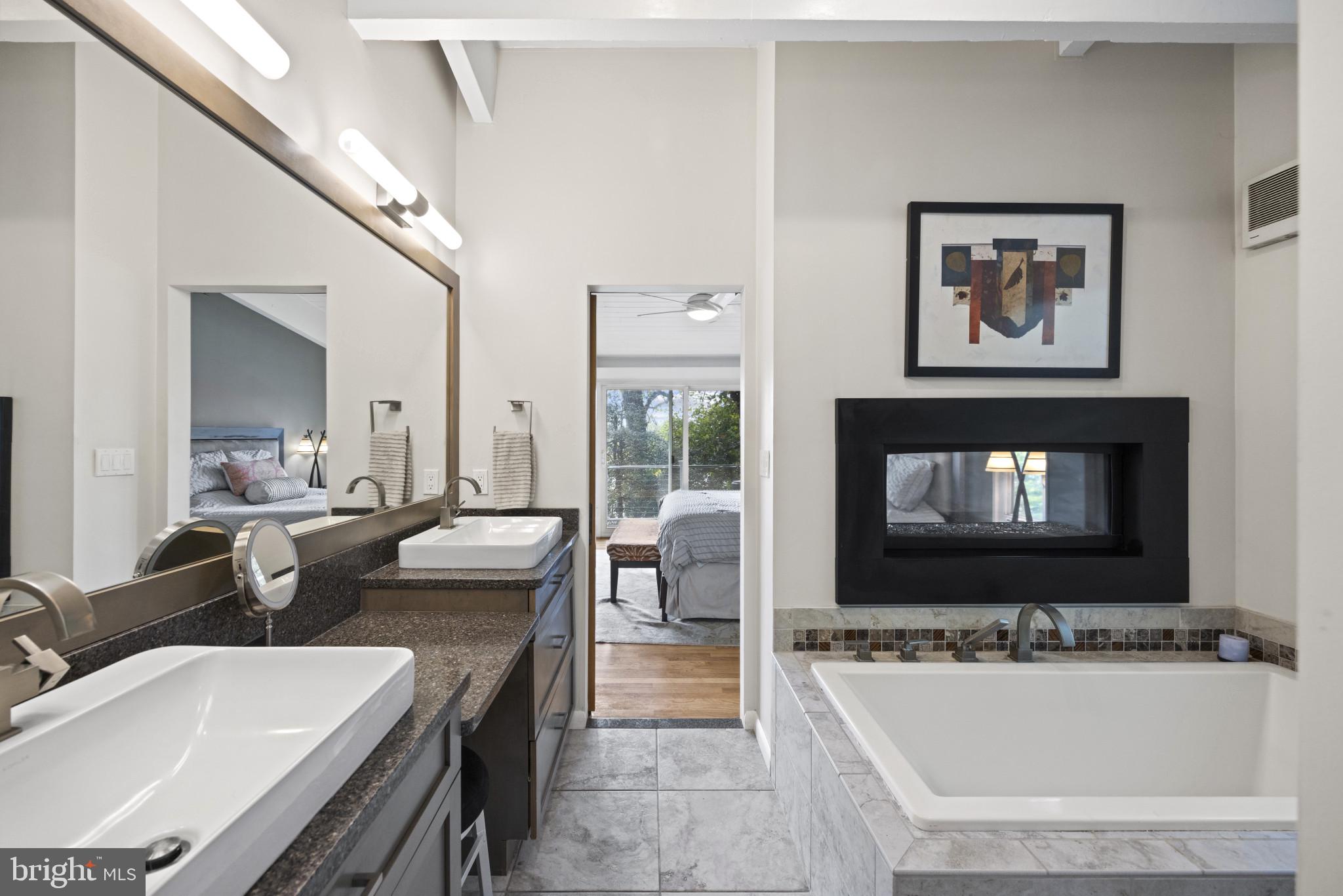 103 Fogle Drive Annapolis, MD 21403 - Photo 15 of 37 a bathroom with a tub double vanity and a large mirror