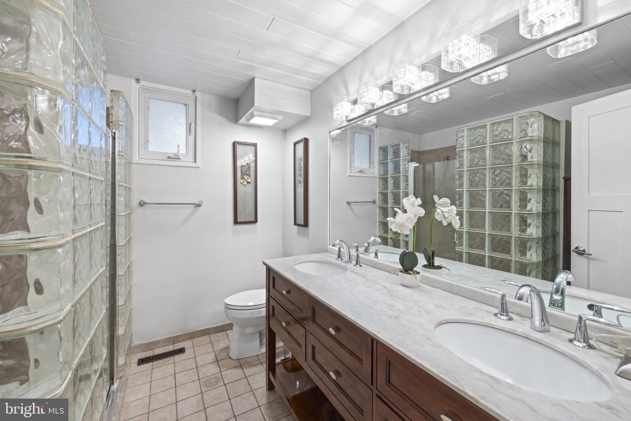 103 Fogle Drive Annapolis, MD 21403 - Photo 22 of 37 a bathroom with a double vanity sink toilet and shower