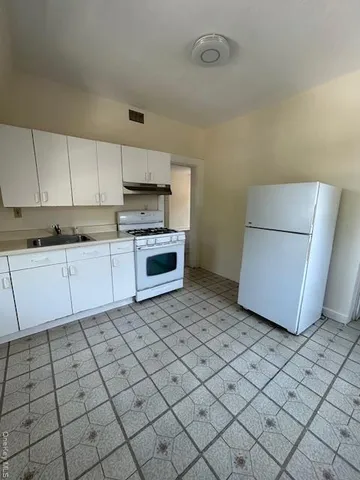 a kitchen with a sink cabinets and appliances