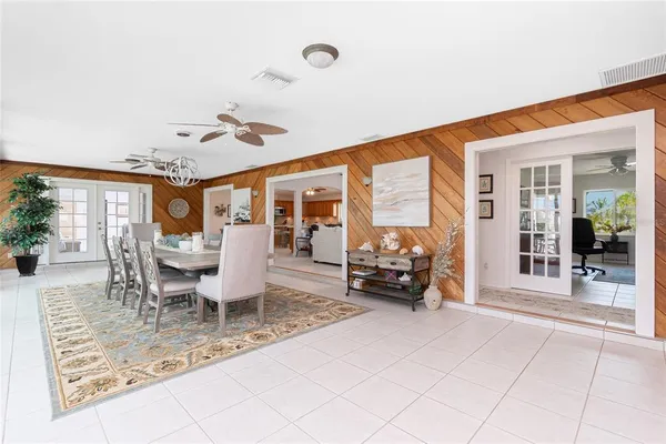 a dining room with furniture and a large window