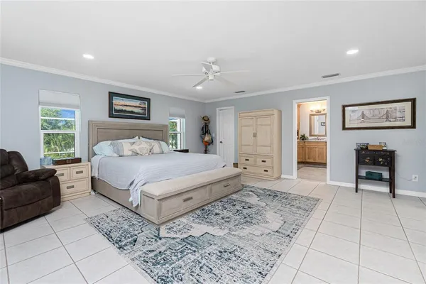 a bedroom with a large bed and a couch