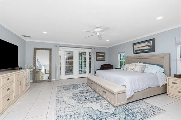 a spacious bedroom with a large bed and a flat screen tv