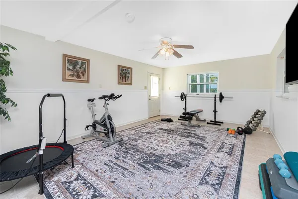 a living room with furniture a window and gym equipment