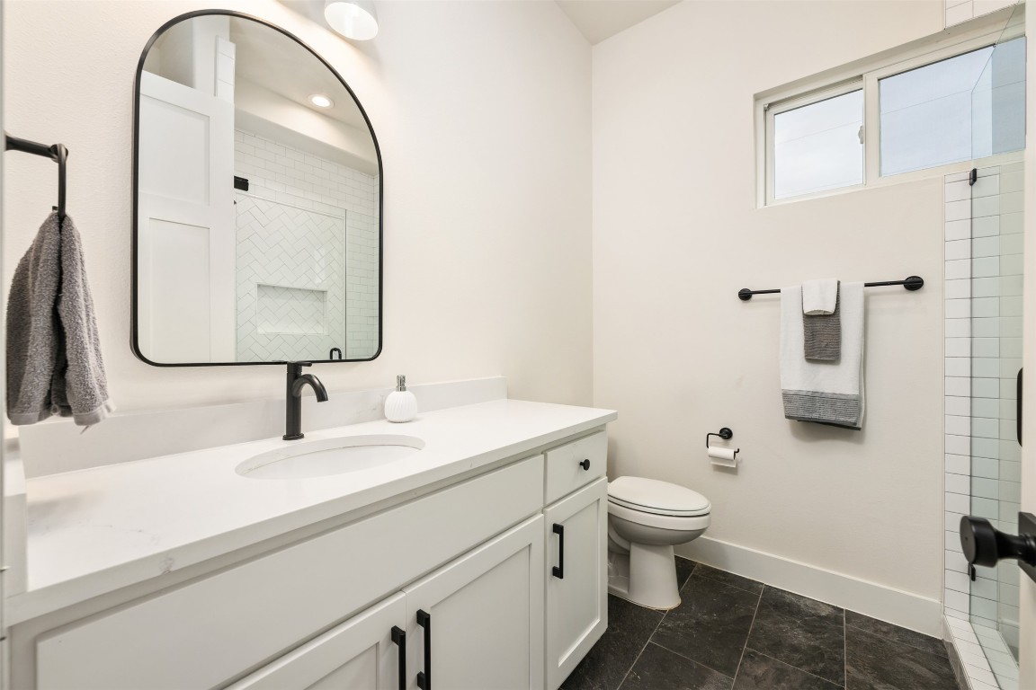 510 East 7th Street Georgetown, TX 78626 - Photo 14 of 40 a bathroom with a sink a toilet and a mirror