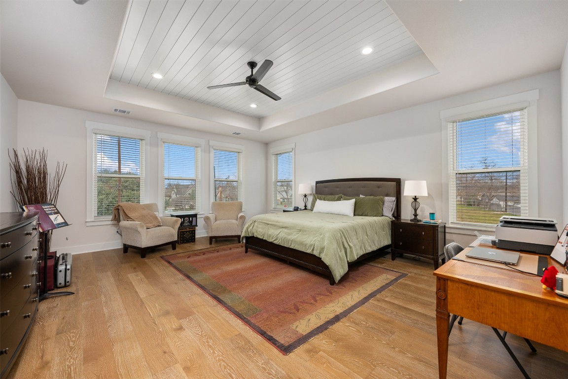 510 East 7th Street Georgetown, TX 78626 - Photo 26 of 40 a spacious bedroom with a bed a couch and large window