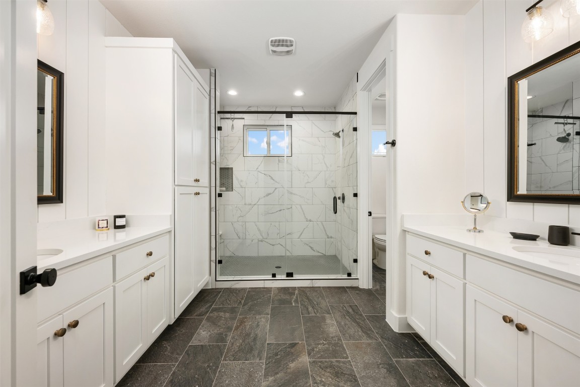 510 East 7th Street Georgetown, TX 78626 - Photo 29 of 40 a bathroom with a double vanity sink toilet and shower