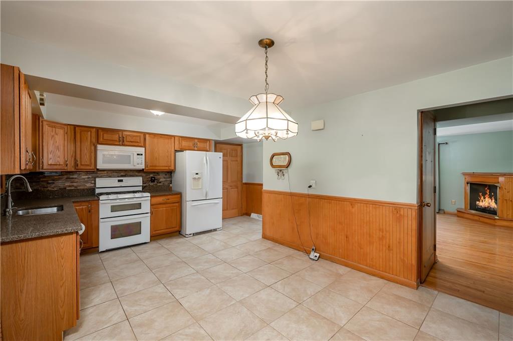 428 Glendale Road Beaver Falls, PA 15010 - Photo 11 of 25 a kitchen with stainless steel appliances granite countertop a stove sink and cabinets
