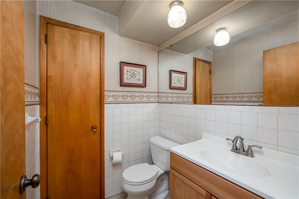 428 Glendale Road Beaver Falls, PA 15010 - Photo 12 of 25 a bathroom with a sink mirror vanity and toilet