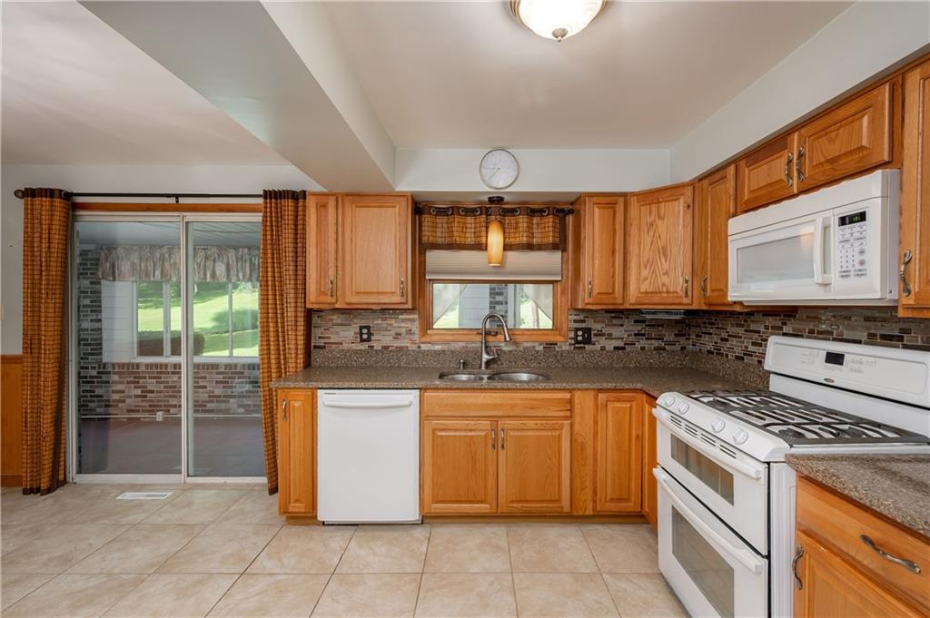 428 Glendale Road Beaver Falls, PA 15010 - Photo 7 of 25 a kitchen with stainless steel appliances granite countertop a stove a sink and a microwave