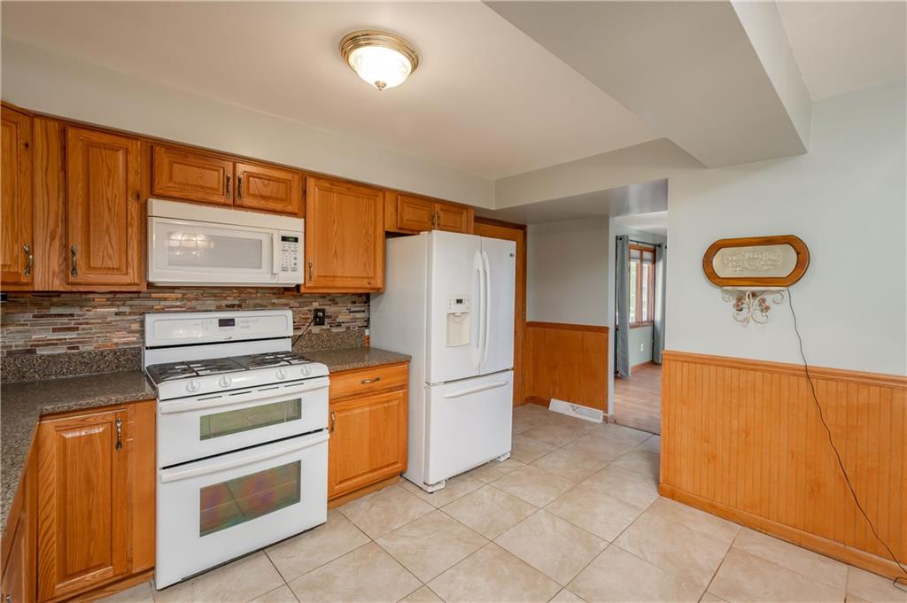 428 Glendale Road Beaver Falls, PA 15010 - Photo 9 of 25 a kitchen with stainless steel appliances a stove a refrigerator and cabinets
