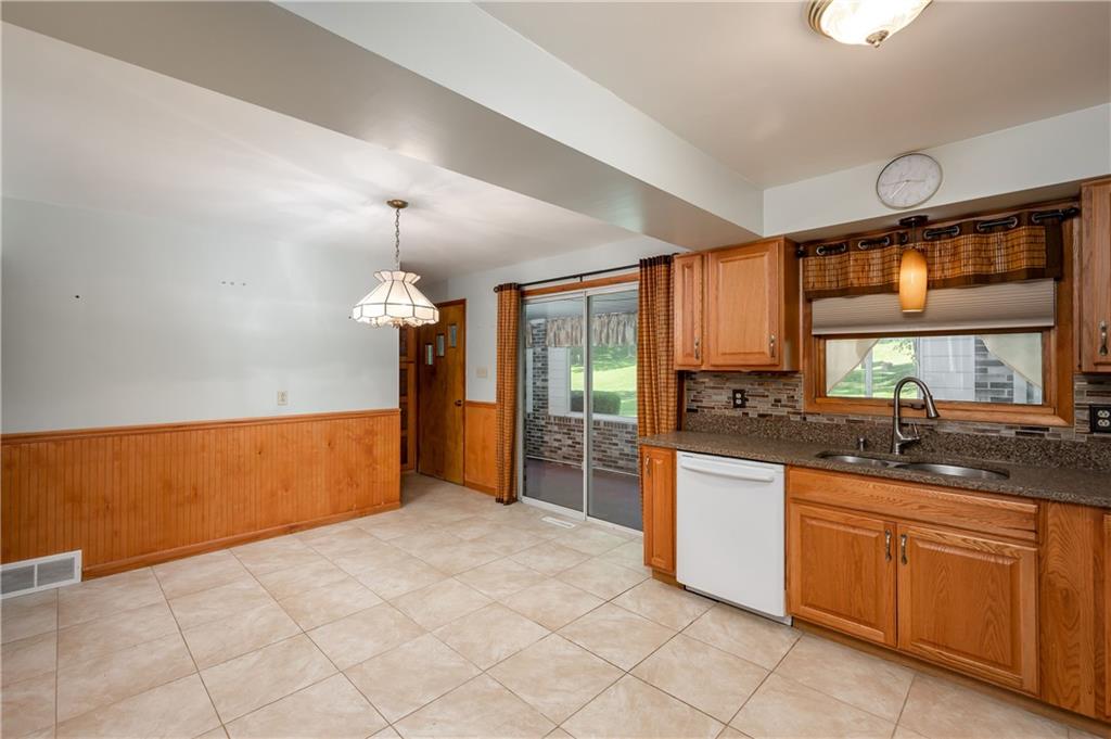 428 Glendale Road Beaver Falls, PA 15010 - Photo 10 of 25 a kitchen with stainless steel appliances granite countertop a sink and a refrigerator