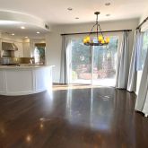 a kitchen with stainless steel appliances granite countertop a stove top oven a sink with wooden floors