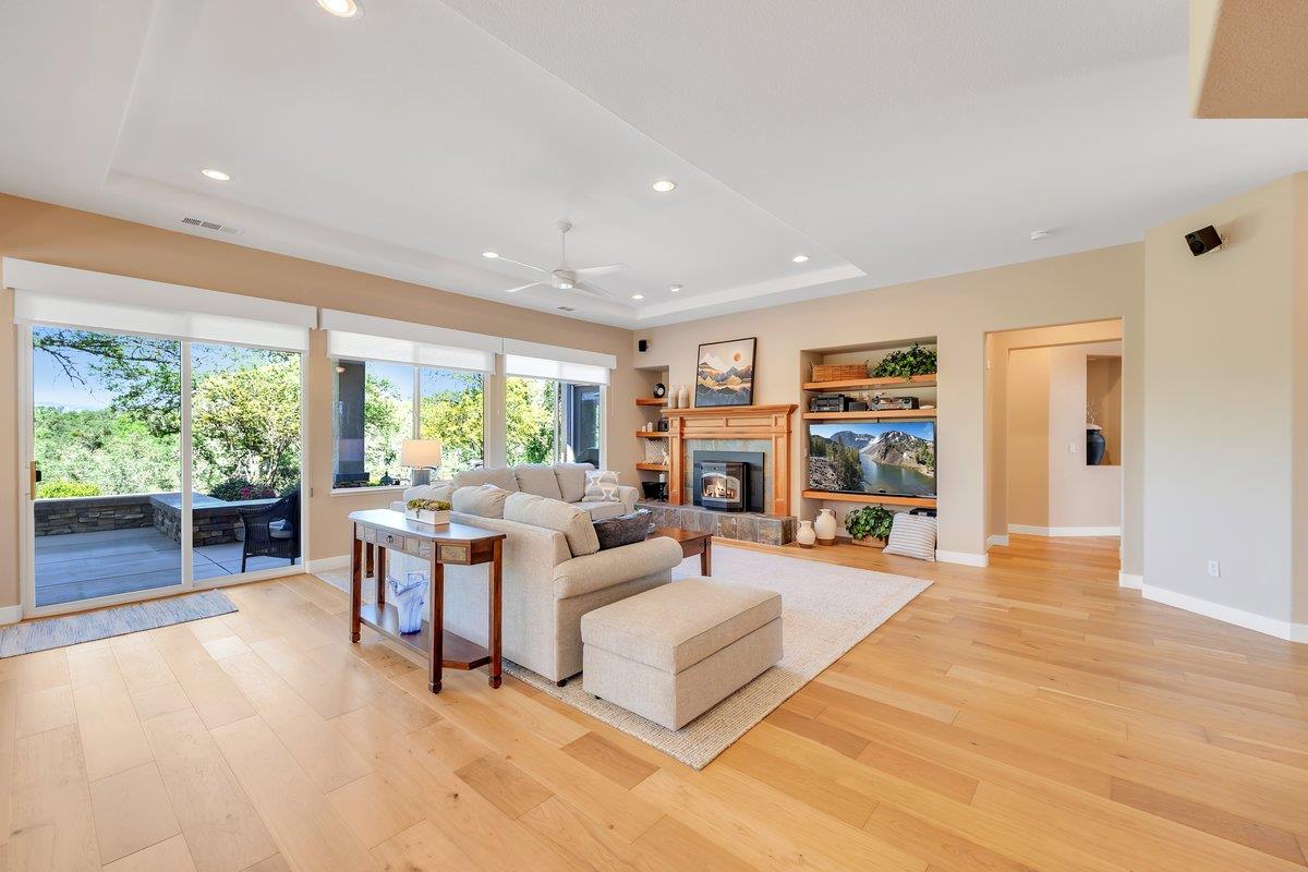 16 Rock Ridge Court, Unit 289 Copperopolis, CA 95228 - Photo 16 of 80 Open Great Room with built in shelves, Pellet Stove, Large windows, Sliding door to the patio, Shaw White Oak Engineered Hardwood Flooring. Hunter Douglass Shades