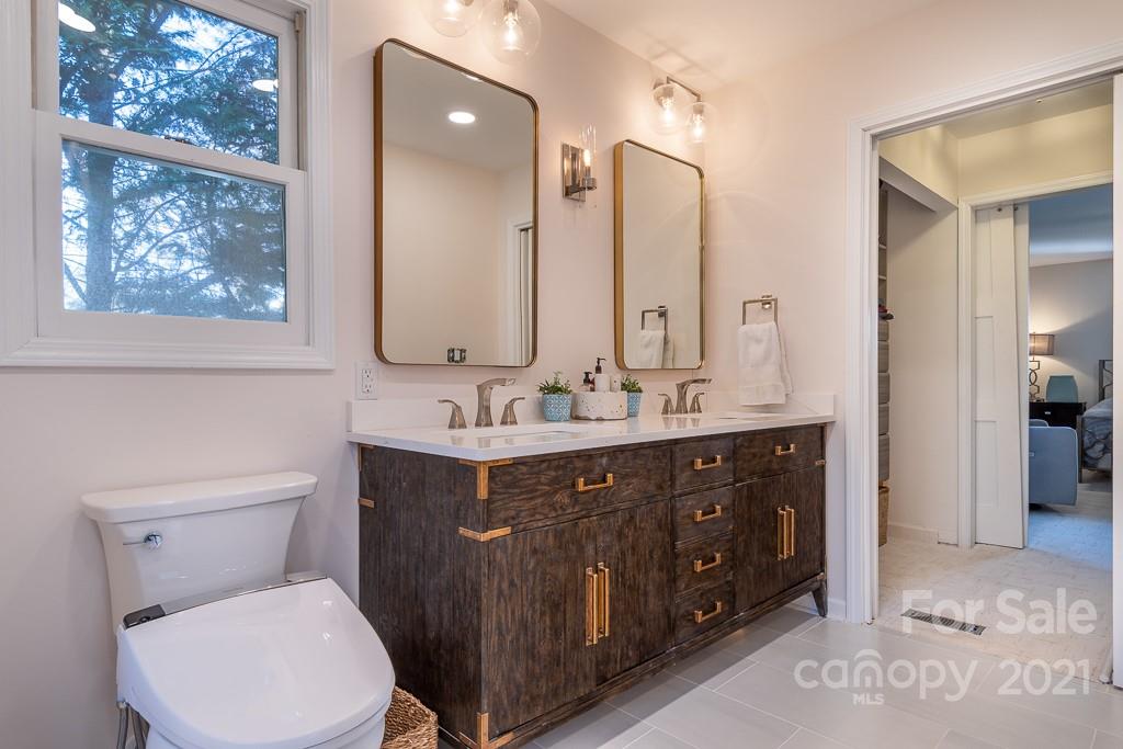 3561 Lake Shore Road South Denver, NC 28037 - Photo 11 of 29 a bathroom with a toilet a sink a mirror and a window
