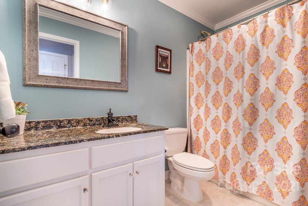 3561 Lake Shore Road South Denver, NC 28037 - Photo 13 of 29 a bathroom with a granite countertop sink mirror vanity and toilet