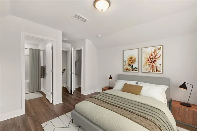 a bedroom with a bed and wooden floor