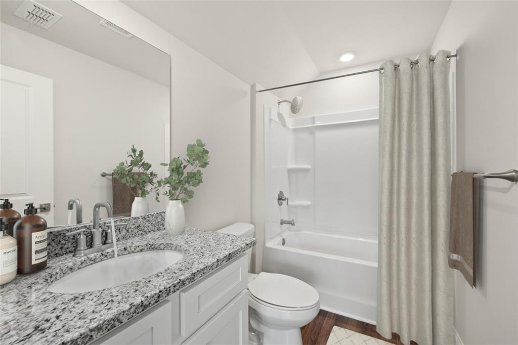 100 Agee Lane, Unit WILMONT McDonough, GA 30253 - Photo 22 of 38 a bathroom with a granite countertop sink a toilet and shower