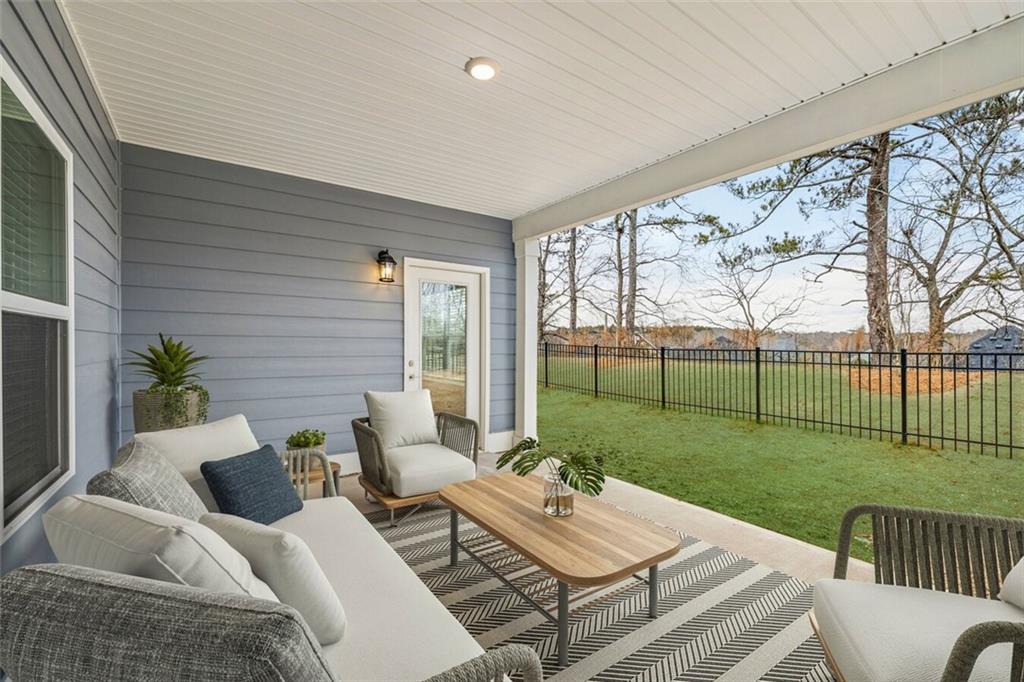 100 Agee Lane, Unit WILMONT McDonough, GA 30253 - Photo 28 of 38 a view of a patio with couches potted plants and wooden fence